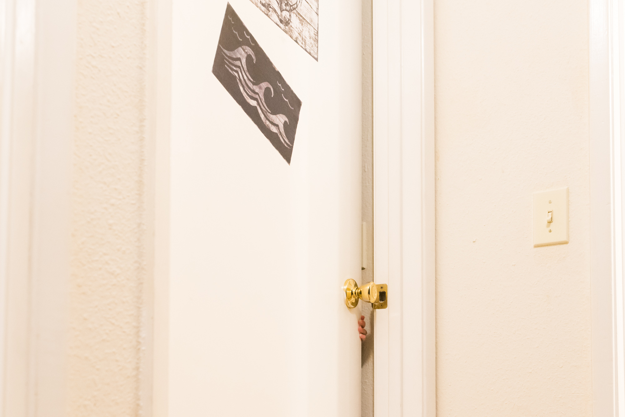 boy slowly opens door - documentary photography military families