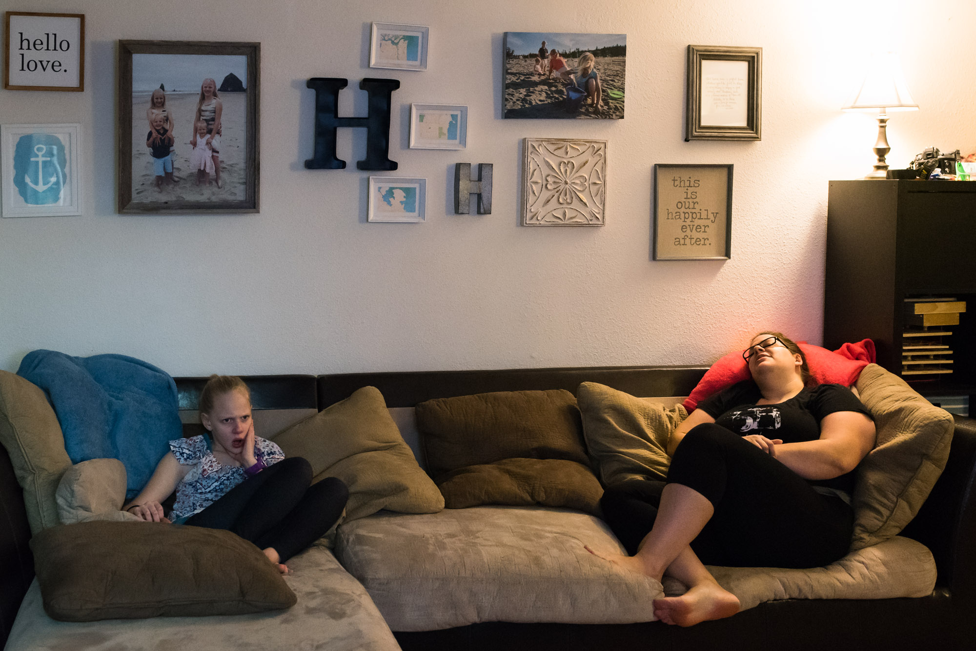 mom relaxes on couch with daughter - documentary photography military families