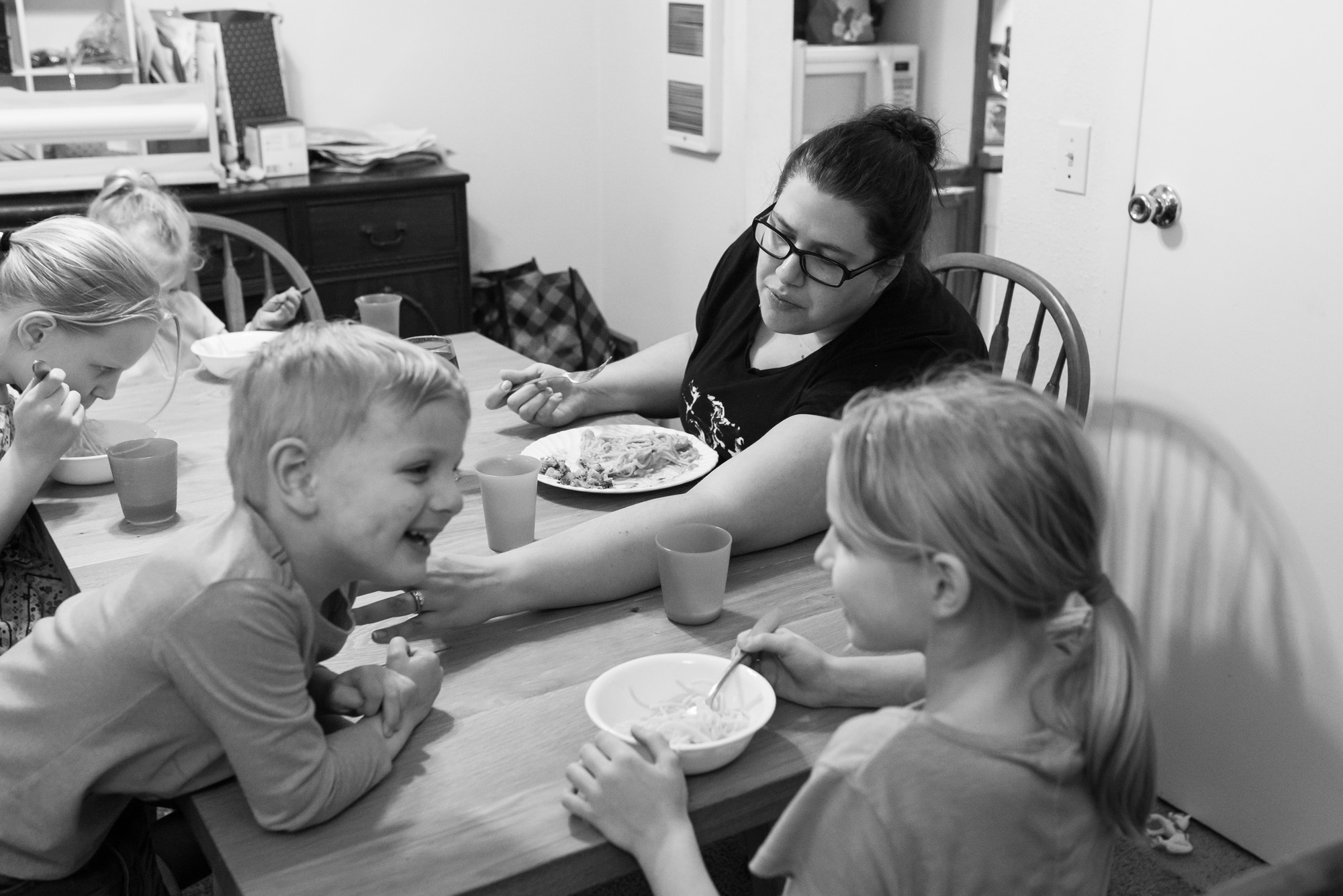 mom gently scolds son at dinner -documentary photography military families