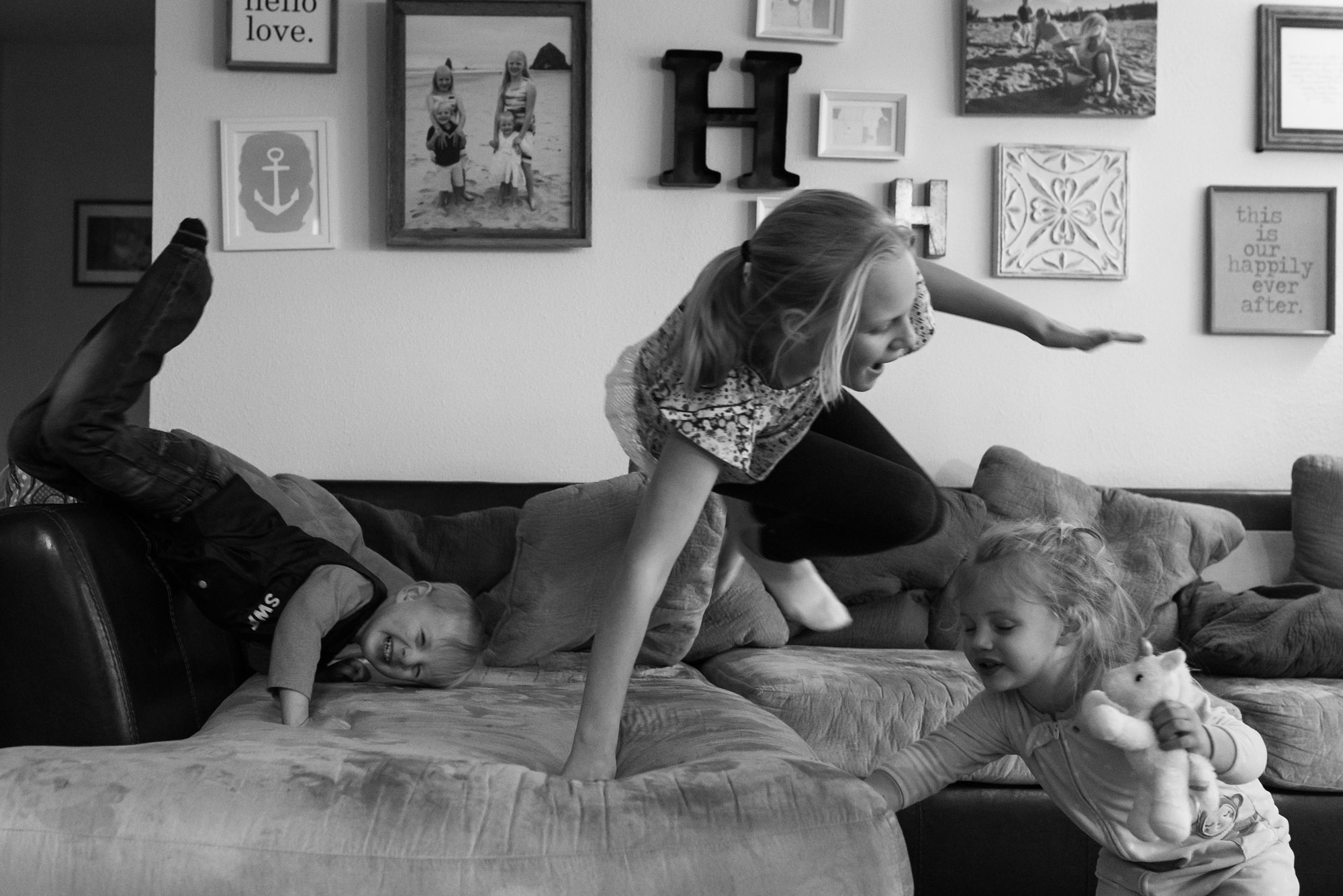 kids play wildly on couch - documentary photography military families
