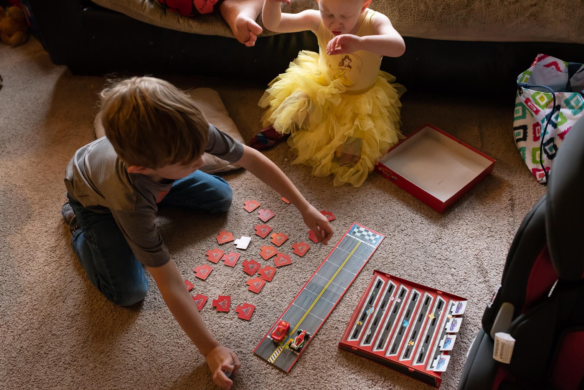 brother and sister play board game -documentary photography of military families
