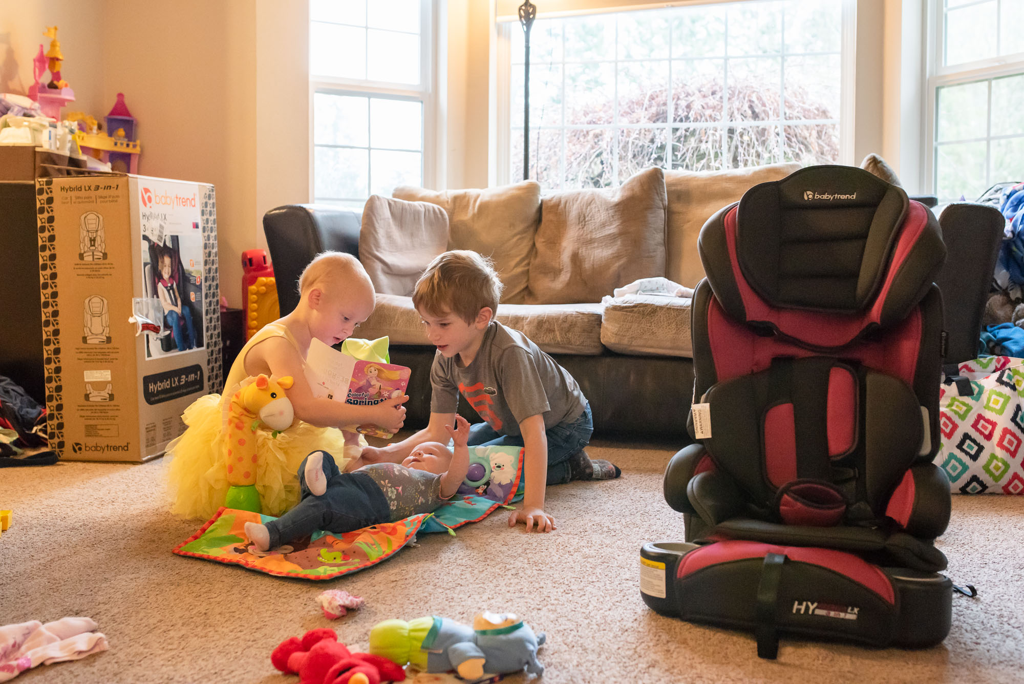 brother and sister play with baby -documentary photography of military families