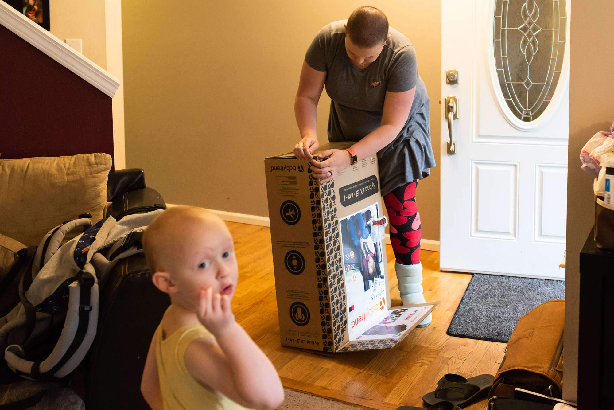 mom deconstructs large box - documentary photography of military families