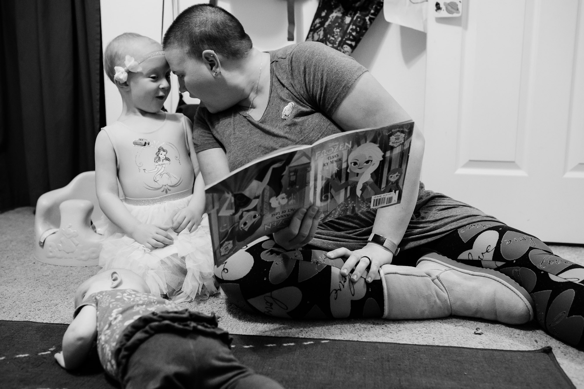 mother shares moment with daughter while reading book 0 documentary photography of military families