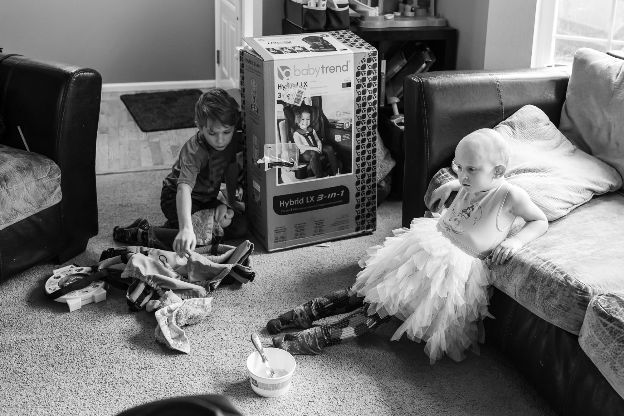 brother and sister look bored in living room - documentary photography of military families