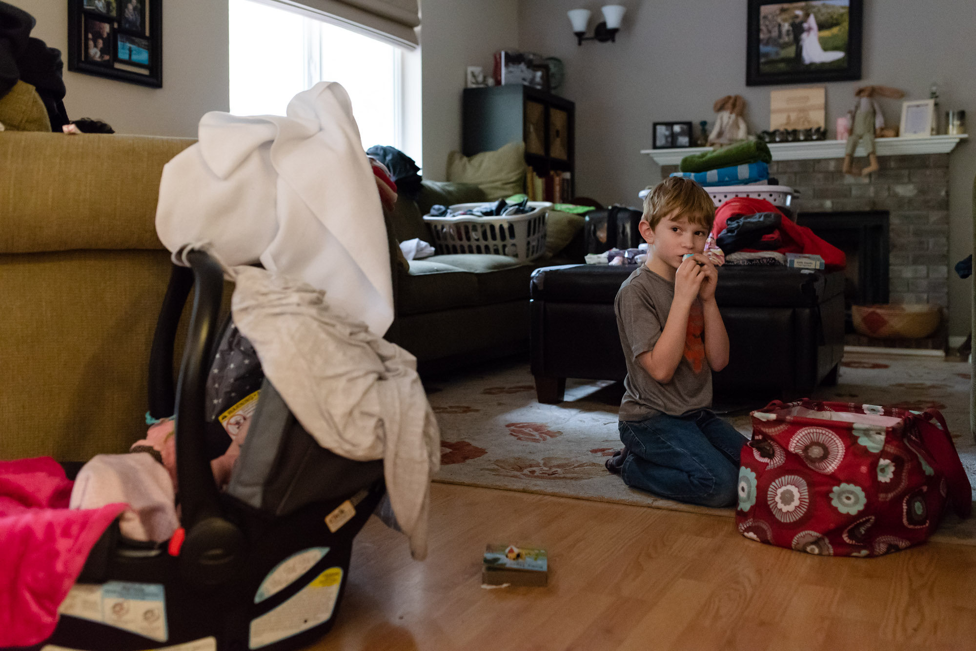 boy eats candy from bag - documentary photography of military families