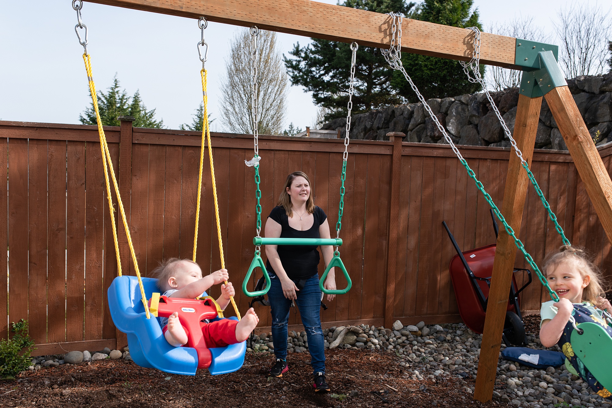 mom pushes kids on swing - submarine family during deployment