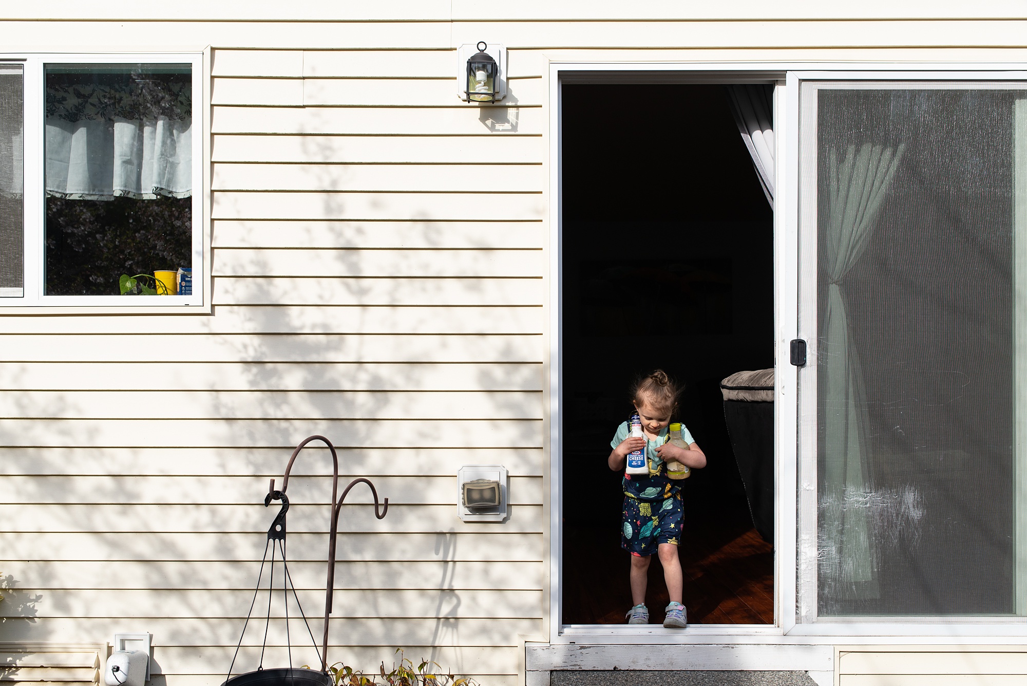 girl brings food into backyard for dinner
