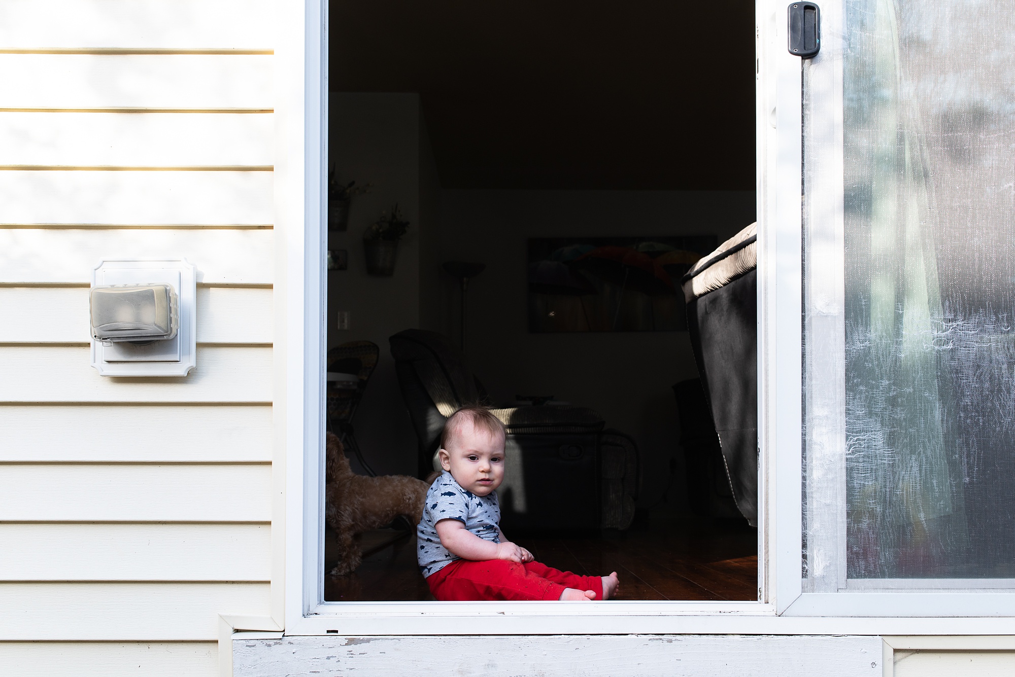 baby waits in doorway