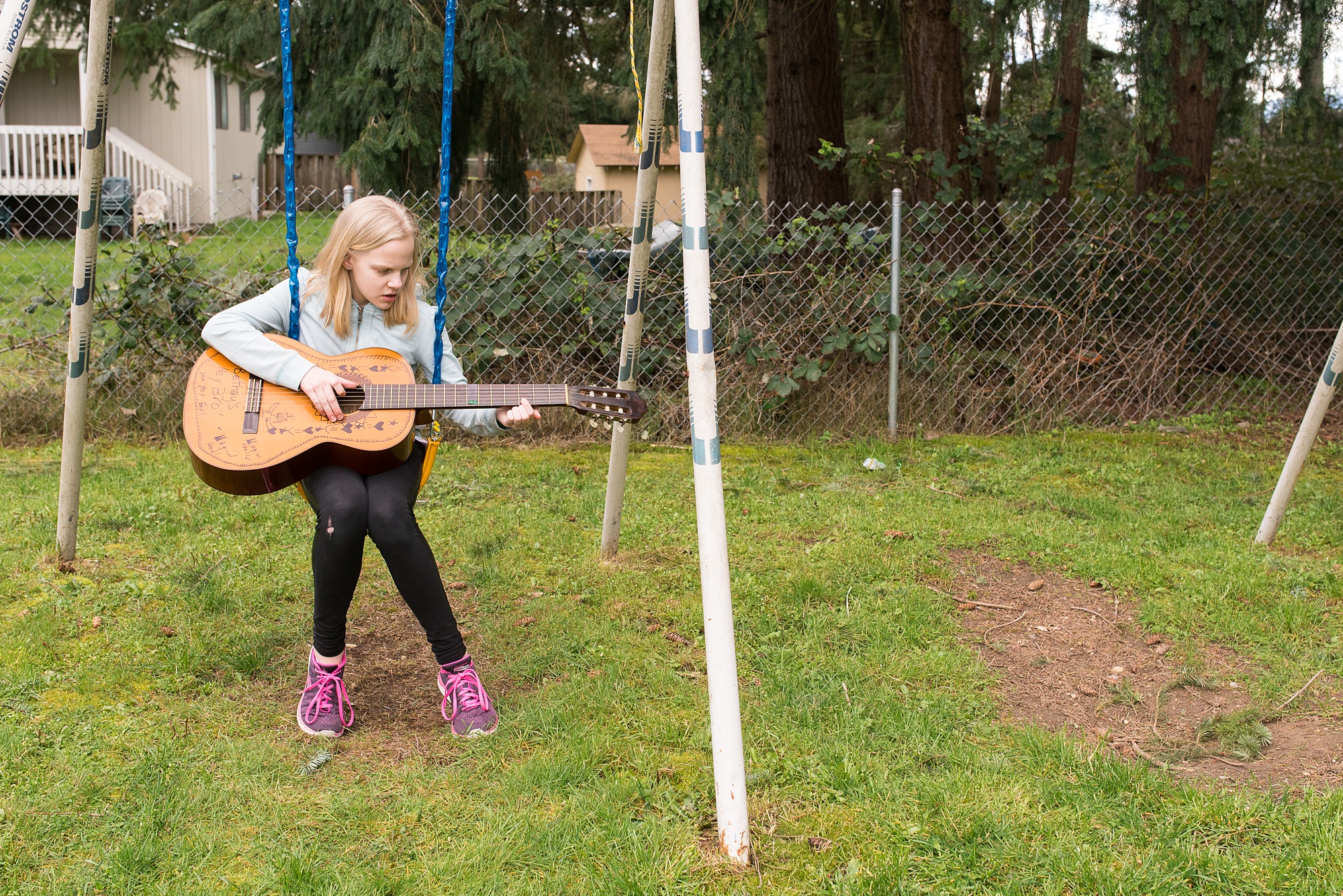 girl on swing with guitar - military family photography
