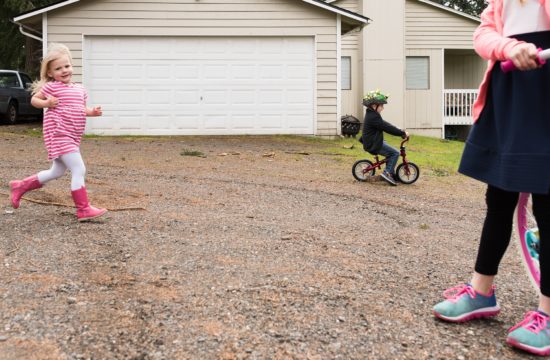 kids riding bikes in driveway - military family photography