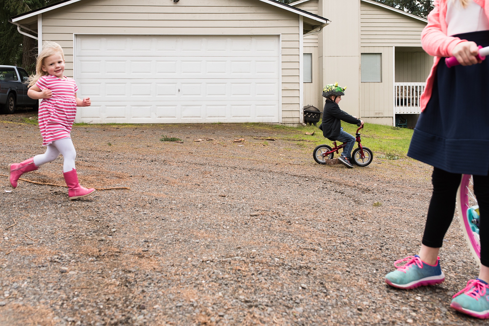 kids riding bikes in driveway - military family photography