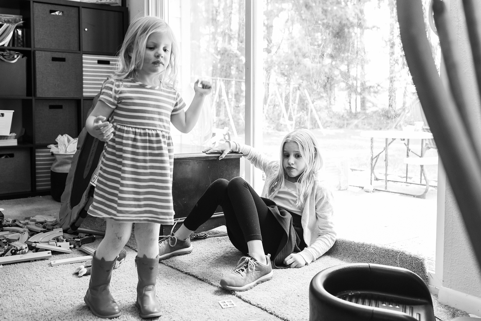 girl slumps near window, bored - military family photography