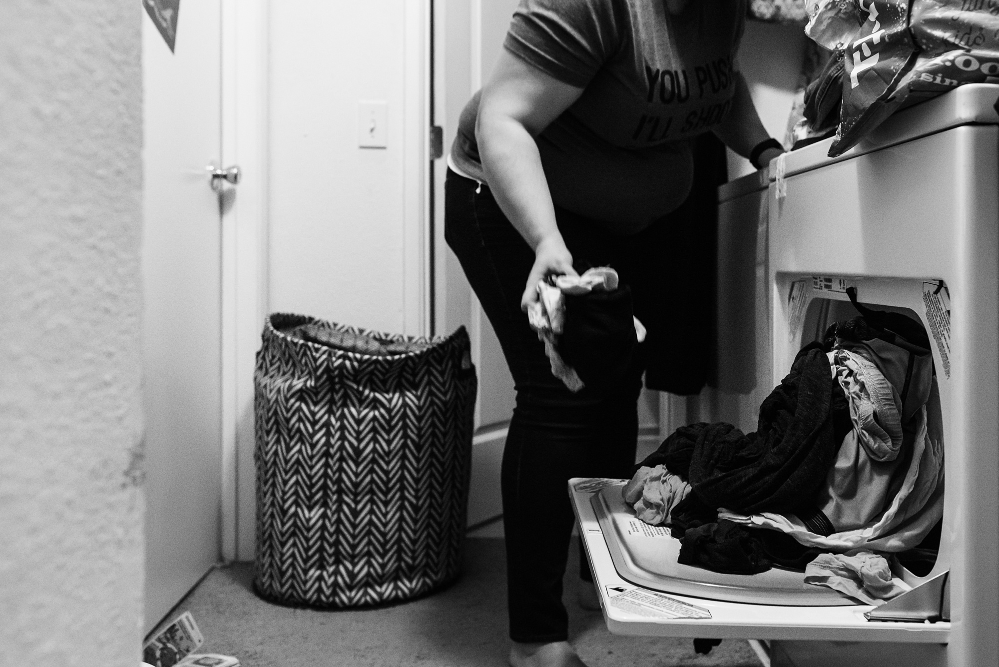 mom loading clothes into dryer - military family photography