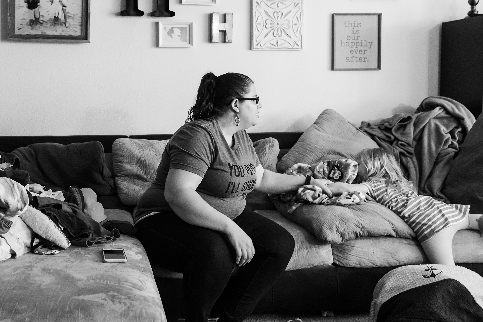 mom with daughter sliding off of couch - military family photography