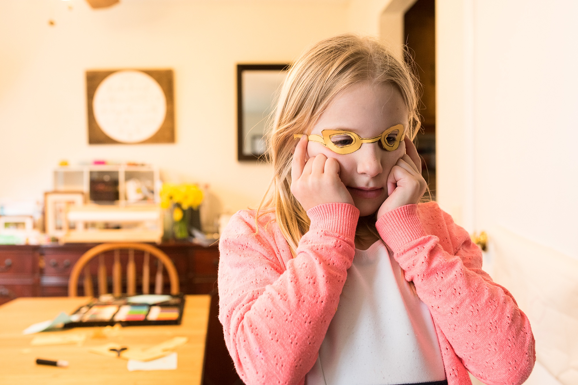 girl crafts glasses from paper - military family photography