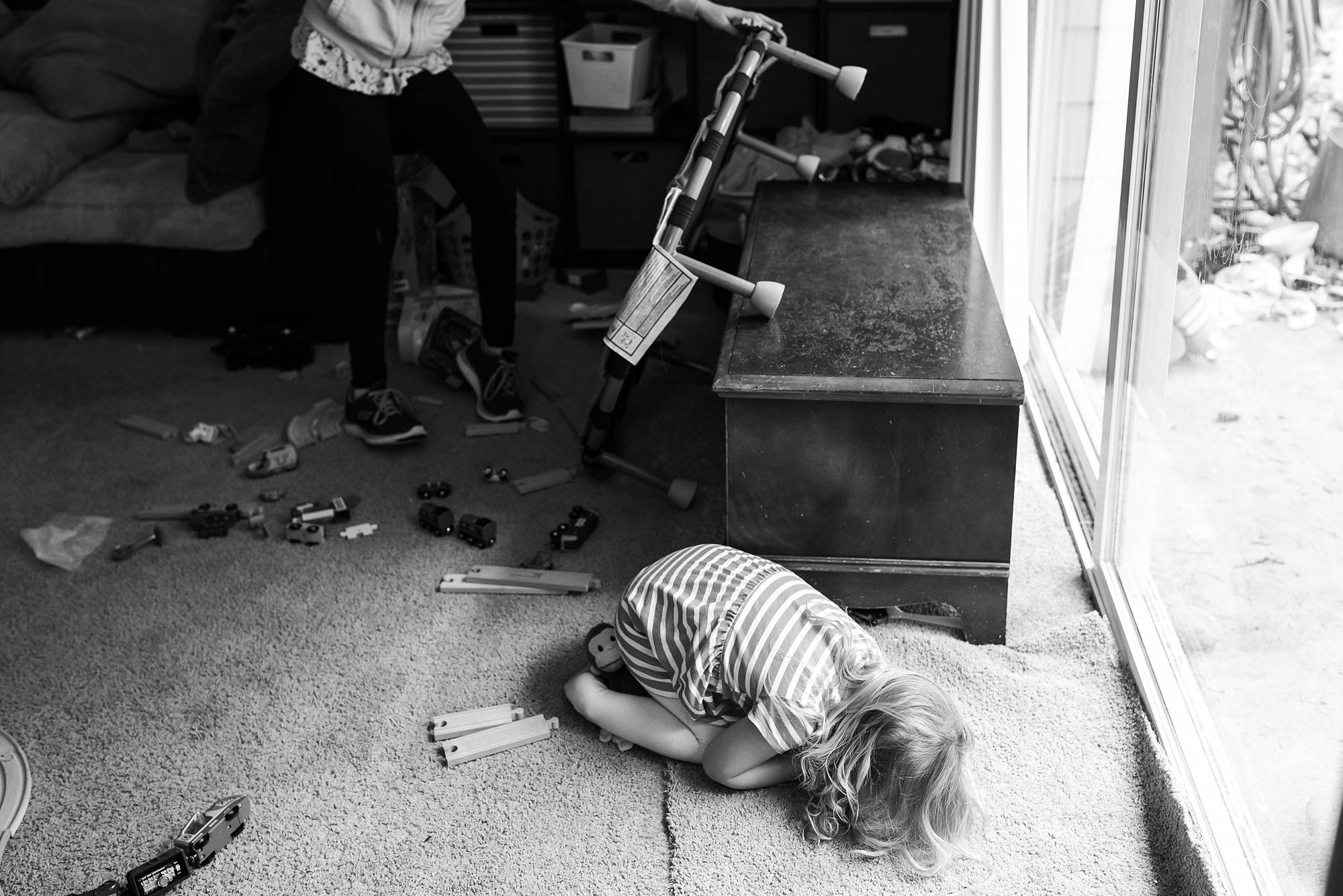 young girl curls up on floor - military family photography