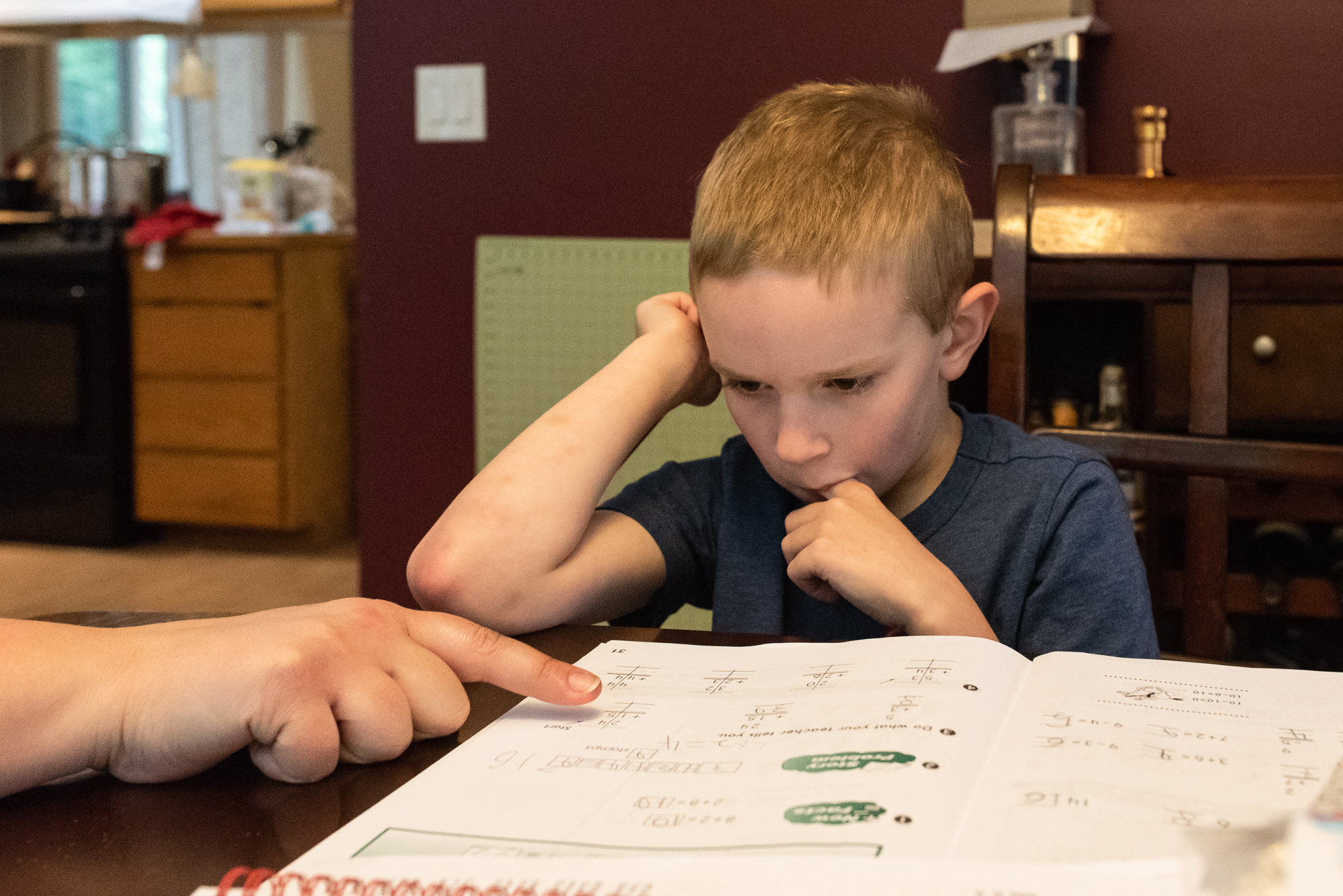 boy concentrates on homework